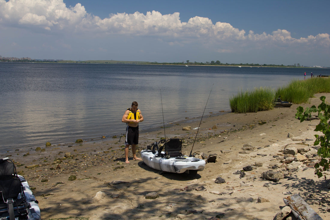 kayaker putting on personal flotation device