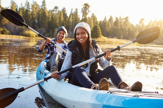 couple staying warm and dry on a sit on top kayak