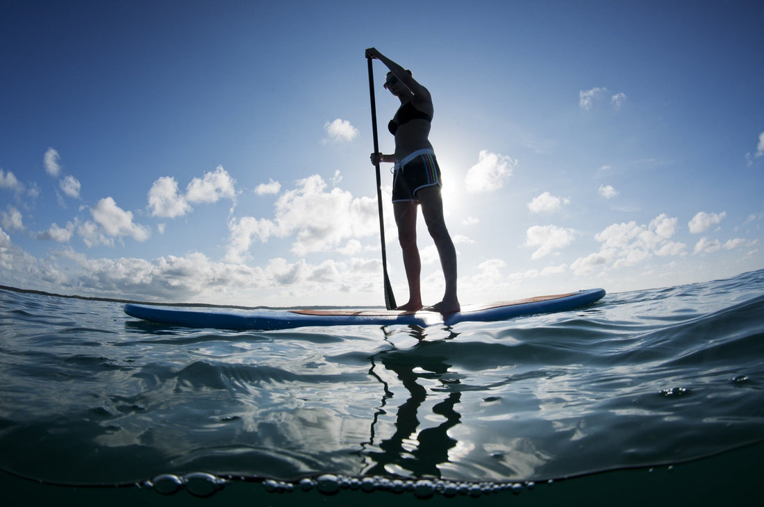 woman paddling a stand up paddle board