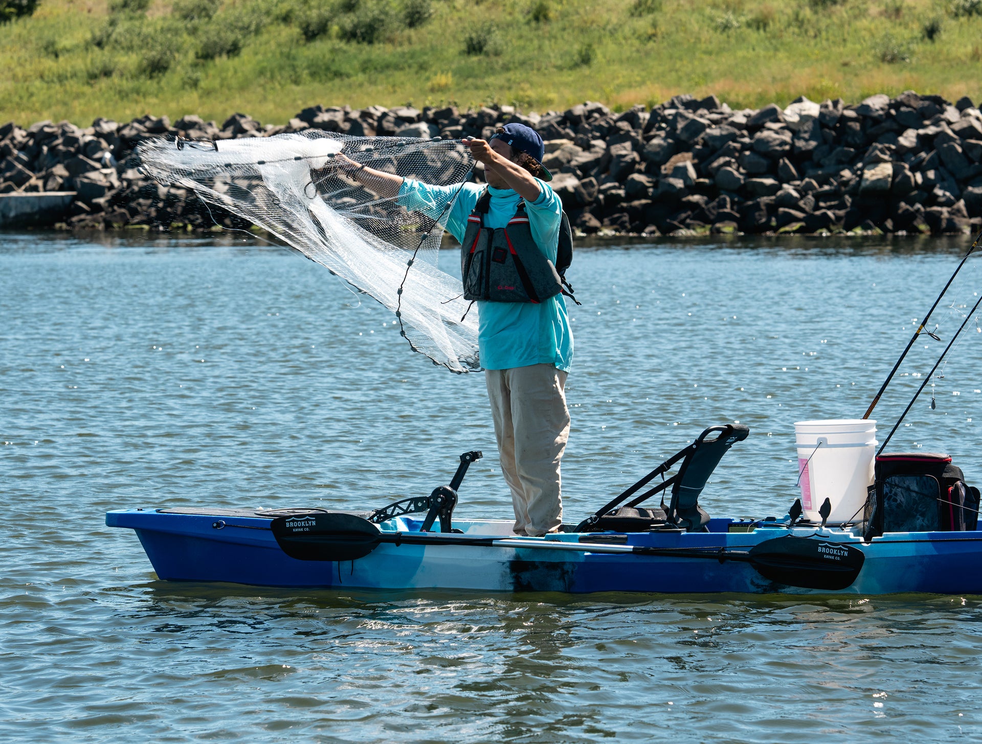 angler tossing net from 12.5 Single Pedal Kayak - Brooklyn Kayak Company